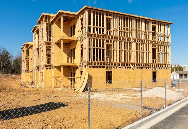 a close-up of temporary chain link fences enclosing a construction site, signaling progress in the project's development in Wolcott